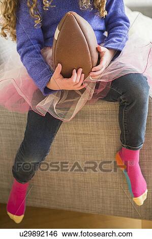 Girl (10-11) wearing tutu playing with football View Large Photo Image Stock Photograph - Girl (10-11) wearing tutu playing with football. Fotosearch