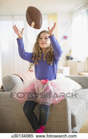 Girl (10-11) wearing tutu playing with football View Large Photo Image Stock Photography - Girl (10-11) wearing tutu playing with football. Fotosearch