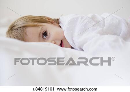 Girl (2-3) lying on bed View Large Photo Image Stock Image - Girl (2-3) lying on bed. Fotosearch