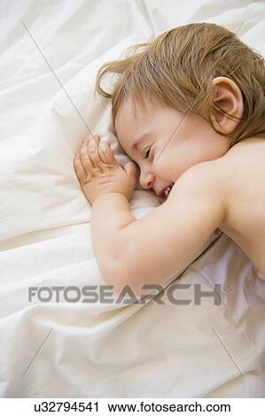 Girl (2-3) playing on bed View Large Photo Image Stock Image - Girl (2-3) playing on bed. Fotosearch