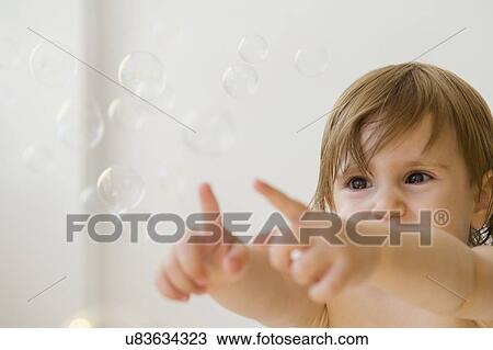 Girl (2-3) playing with bubbles View Large Photo Image Stock Image - Girl (2-3) playing with bubbles. Fotosearch