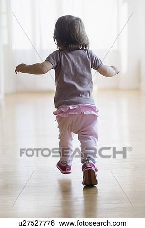 Stock Photograph - Girl (2-3) running on floor. Fotosearch