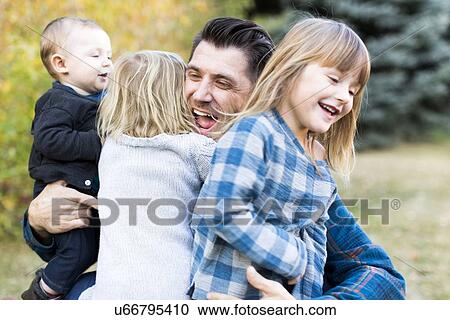 "Happy family with tree children (6-11 months, 2-3, 4-5) playing in park" View Large Photo Image Stock Image - "Happy family with tree children (6-11 months, 2-3, 4-5) playing in park". Fotosearch