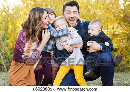"Happy family with tree children (6-11 months, 2-3, 4-5) playing in park" View Large Photo Image Stock Photo - "Happy family with tree children (6-11 months, 2-3, 4-5) playing in park". Fotosearch