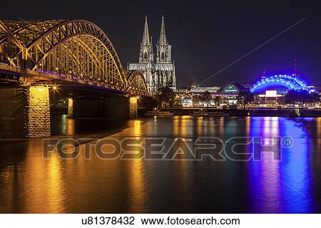 Hohenzollern Bridge and Cologne Cathedral illuminated at night View Large Photo Image Stock Image - Hohenzollern Bridge and Cologne Cathedral illuminated at night. Fotosearch