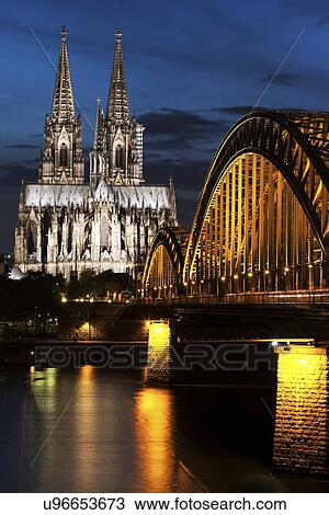 Stock Image - Hohenzollern Bridge and Cologne Cathedral illuminated at night. Fotosearch