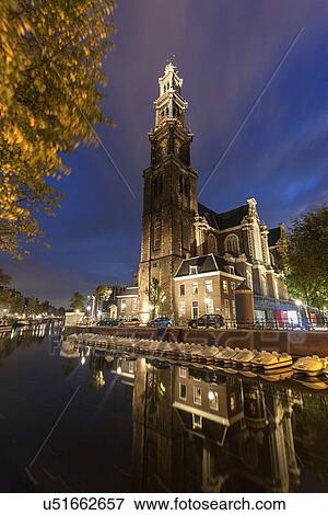 Illuminated Westerkerk Church reflecting in still canal View Large Photo Image Stock Photo - Illuminated Westerkerk Church reflecting in still canal . Fotosearch