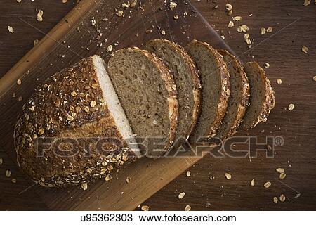 Stock Image - Loaf of bread on wooden table. Fotosearch
