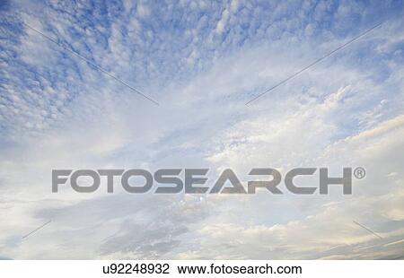 Stock Image - Low angle view of cloudscape. Fotosearch