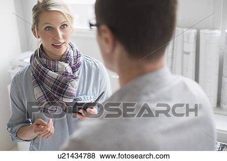 Man and woman talking in office View Large Photo Image Stock Photo - Man and woman talking in office. Fotosearch