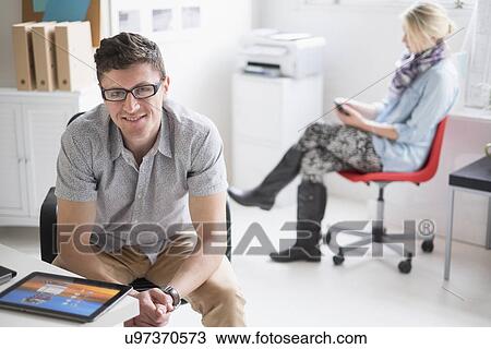 Man and woman working in office View Large Photo Image Stock Image - Man and woman working in office. Fotosearch