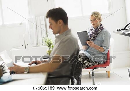 Man and woman working in office View Large Photo Image Stock Photo - Man and woman working in office. Fotosearch