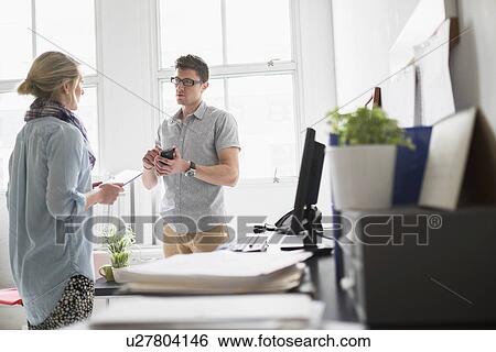 Man and woman working in office View Large Photo Image Stock Photograph - Man and woman working in office. Fotosearch