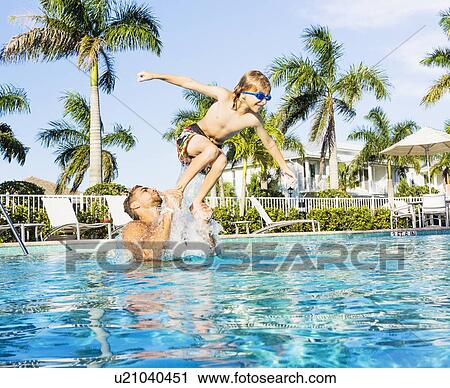 Man swimming with his brother (8-9) View Large Photo Image Stock Image - Man swimming with his brother (8-9). Fotosearch