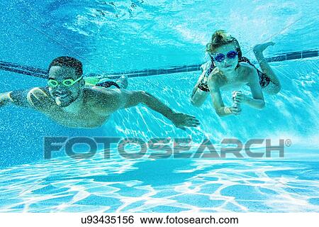 Man swimming with his brother (8-9) View Large Photo Image Stock Photograph - Man swimming with his brother (8-9). Fotosearch