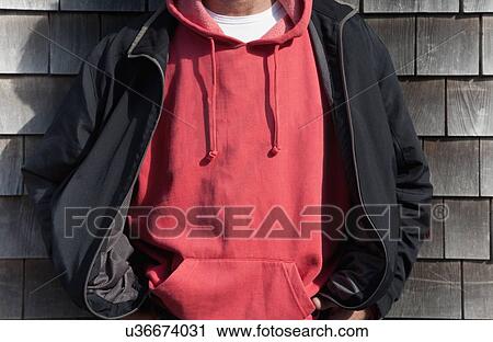 Man wearing red hooded shirt View Large Photo Image Stock Image - Man wearing red hooded shirt. Fotosearch