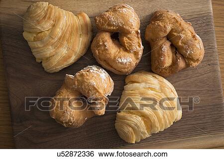 Stock Photograph - Old fashioned donuts and sfogliatella pastries. Fotosearch