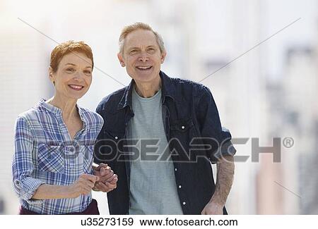 Stock Photo - Outdoor portrait of smiling senior couple . Fotosearch