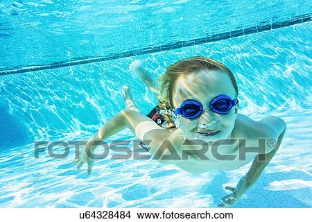 Portrait of boy (8-9) in swimming pool View Large Photo Image Picture - Portrait of boy (8-9) in swimming pool. Fotosearch