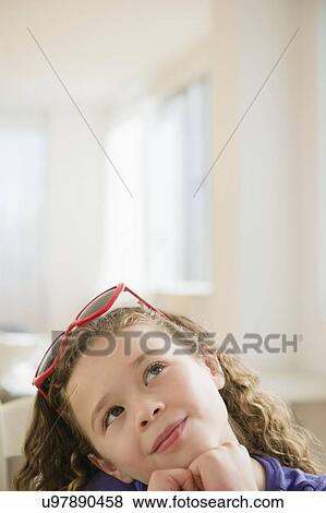 Stock Photo - Portrait of girl (10-11) looking up. Fotosearch