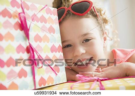 Portrait of girl (10-11) with gift boxes View Large Photo Image Picture - Portrait of girl (10-11) with gift boxes. Fotosearch