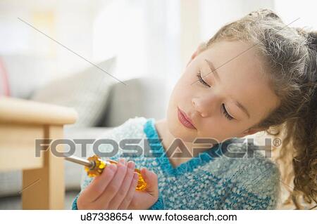 Portrait of girl (10-11) with screwdriver View Large Photo Image Picture - Portrait of girl (10-11) with screwdriver. Fotosearch