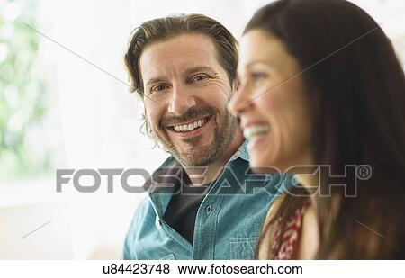Portrait of man sitting with girlfriend on sofa View Large Photo Image Stock Photo - Portrait of man sitting with girlfriend on sofa. Fotosearch