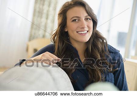 Portrait of smiling woman at home View Large Photo Image Stock Photograph - Portrait of smiling woman at home. Fotosearch