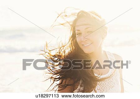 Stock Image - Portrait of woman on beach. Fotosearch
