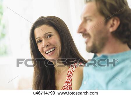 Portrait of woman sitting with boyfriend on sofa View Large Photo Image Stock Photo - Portrait of woman sitting with boyfriend on sofa. Fotosearch