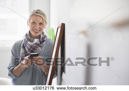 Portrait of woman using cell phone View Large Photo Image Stock Photograph - Portrait of woman using cell phone. Fotosearch