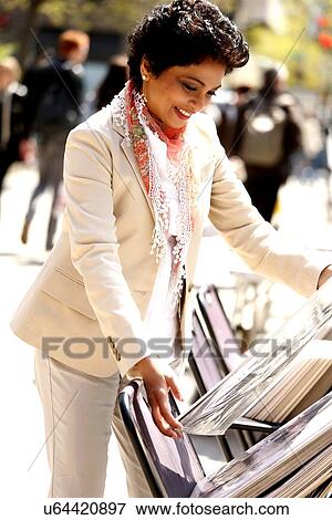 Stock Photo - Portrait of woman watching art on street. Fotosearch