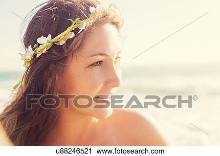 Stock Image - Portrait of woman with flower wreath on head. Fotosearch
