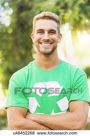 Portrait of young man wearing t-shirt with recycling symbol View Large Photo Image Stock Photo - Portrait of young man wearing t-shirt with recycling symbol. Fotosearch