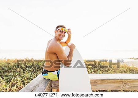 Stock Image - Portrait of young surfer. Fotosearch