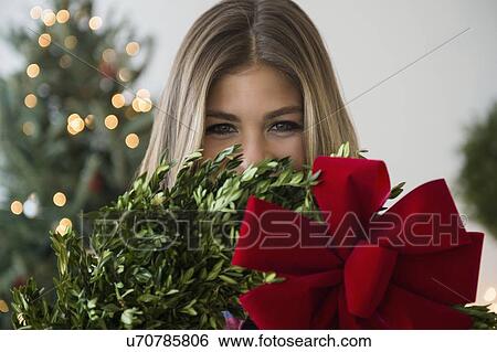 Portrait of young woman with christmas decoration View Large Photo Image Stock Photograph - Portrait of young woman with christmas decoration. Fotosearch