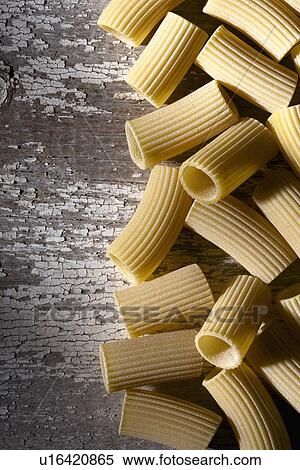 Stock Photography - Rigatoni on weathered surface. Fotosearch