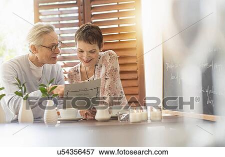 Senior couple looking at menu View Large Photo Image Stock Photo - Senior couple looking at menu. Fotosearch