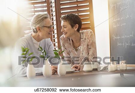 Senior couple sitting in restaurant View Large Photo Image Stock Image - Senior couple sitting in restaurant. Fotosearch