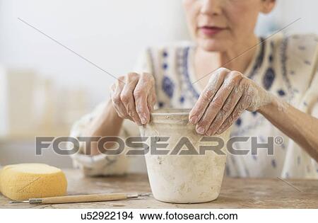 Senior woman making flower pot at workshop View Large Photo Image Picture - Senior woman making flower pot at workshop. Fotosearch