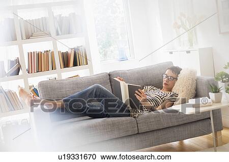 Senior woman reading book on sofa View Large Photo Image Stock Image - Senior woman reading book on sofa. Fotosearch