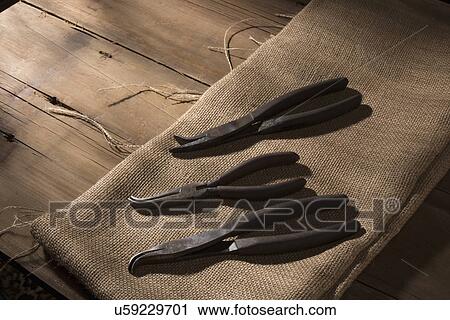 "Silversmith's tools arranged on linen fabric, wooden table" View Large Photo Image Stock Image - "Silversmith's tools arranged on linen fabric, wooden table". Fotosearch