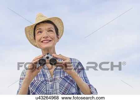 Smiling senior woman with binoculars View Large Photo Image Stock Photo - Smiling senior woman with binoculars. Fotosearch