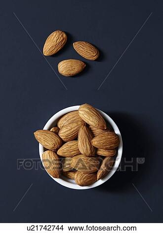 Stack of almonds in ramekin View Large Photo Image Picture - Stack of almonds in ramekin. Fotosearch