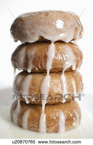 "Stack of donuts with fresh glaze, white background" View Large Photo Image Stock Photography - "Stack of donuts with fresh glaze, white background". Fotosearch