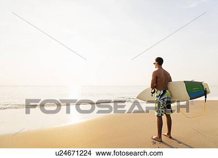 Surfer looking at sunset View Large Photo Image Picture - Surfer looking at sunset. Fotosearch