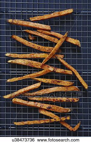 Stock Photograph - Sweet potato fries on rack. Fotosearch