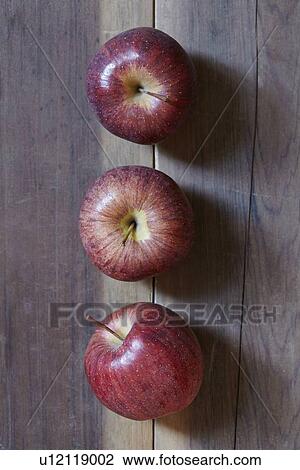 Stock Image - Three apples in row. Fotosearch