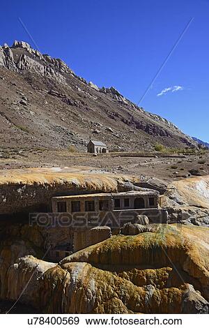 Stock Photo - View old building under natural bridge in valley. Fotosearch