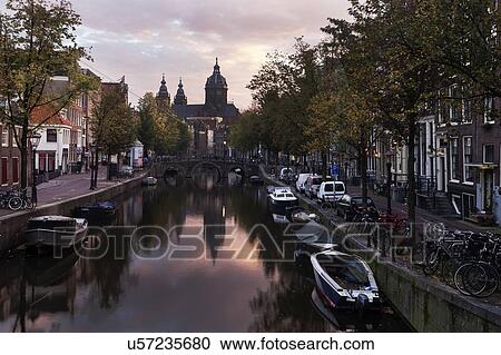 Water canal in city at sunrise View Large Photo Image Stock Image - Water canal in city at sunrise. Fotosearch